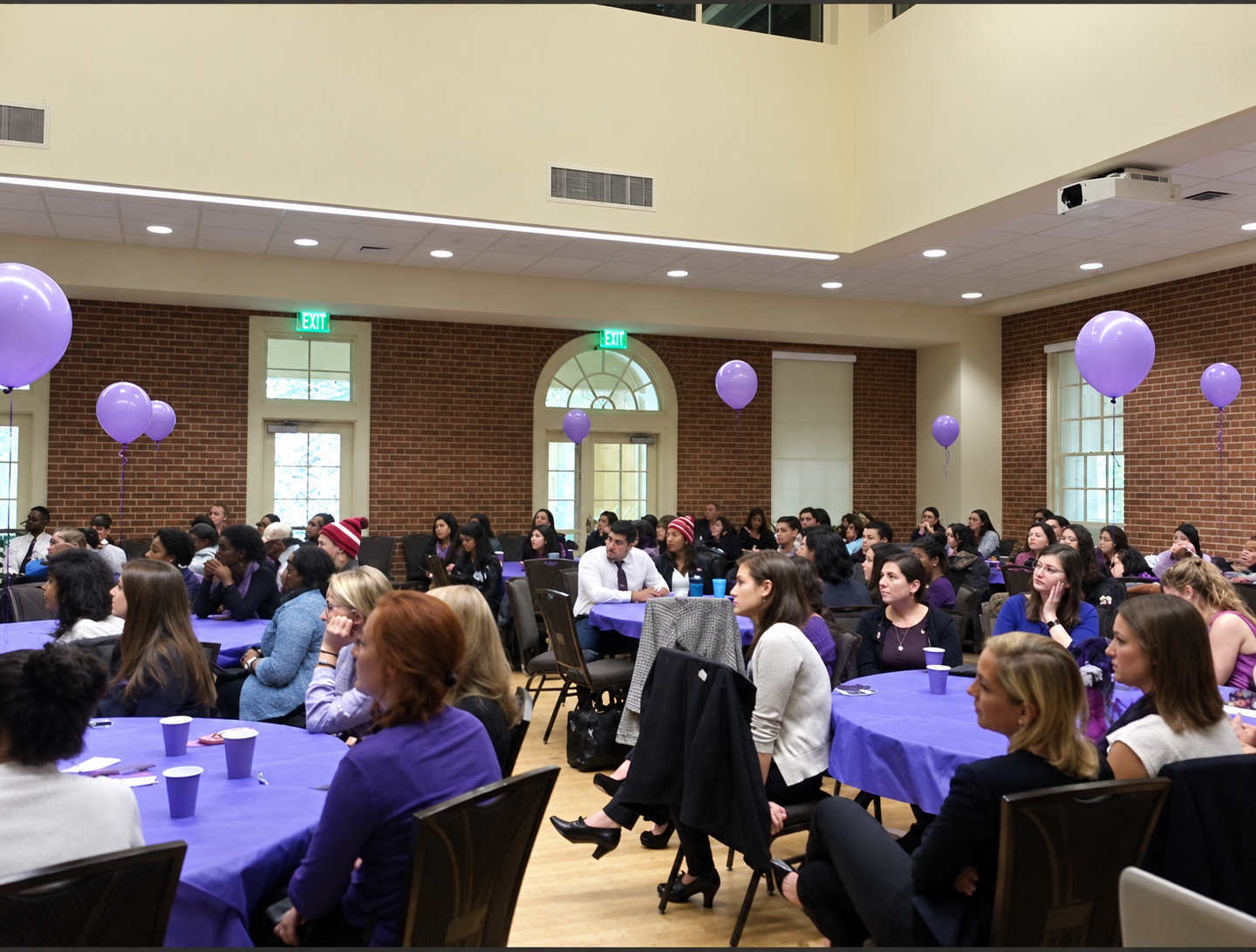 An audience listening at a speaking event